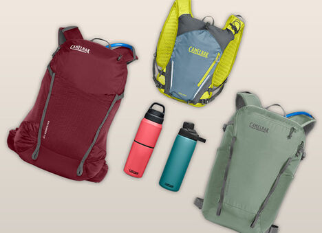 three backpacks and two bottles on a gray background