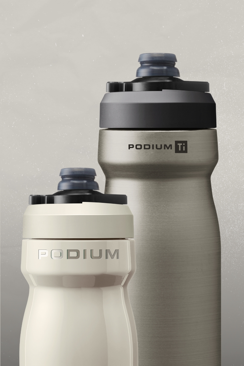 Two podium bottles on a gray gradient background